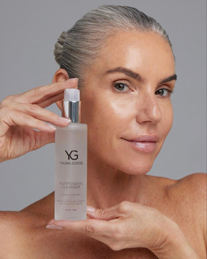 Woman holding a full size bottle of Young Goose Adaptogenic Cleanser Gentle Face Wash #30ML #120ML #180ML