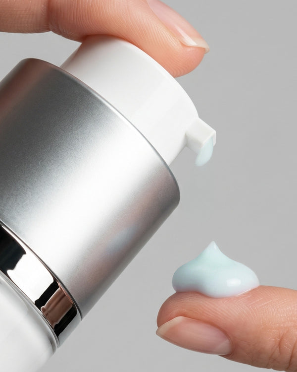 Close-up of a hand applying cream from a bottle of Young Goose C.A.R.E. (CARE) Anti-Aging Moisturizer onto a finger