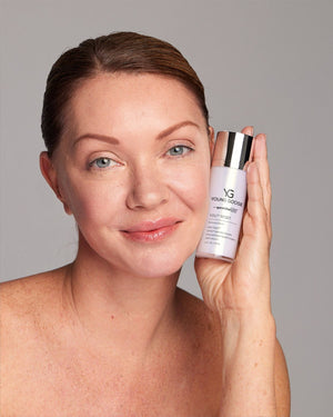 Woman holding a bottle of Young Goose Youth Reset Restorative Serum